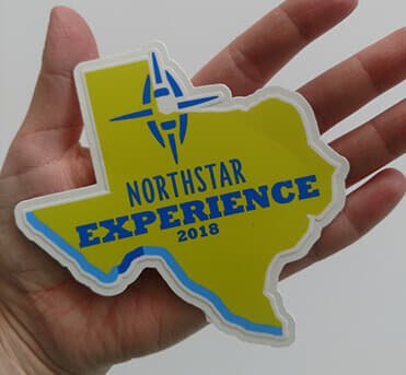 A custom Texas-shaped sticker featuring the Northstar Experience 2018 logo in blue and yellow.